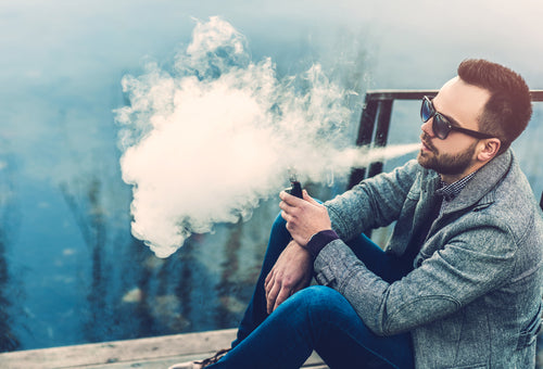 Man with beard vaping